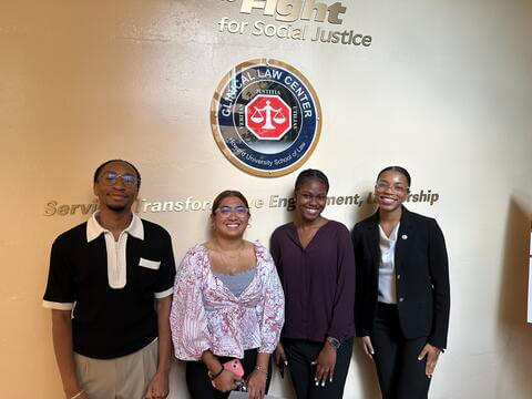 people standing in front of a wall sign