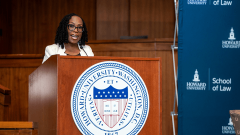 Speaker addressing an audience at a podium during a civil rights moot court event at Howard University School of Law.”